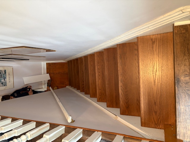 Top down view looking down a beautiful staircase with new luxury vinyl plank flooring installation